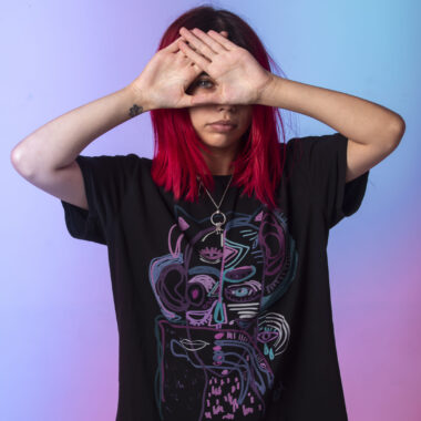 Young girl with pink hairs crossing her hands to her face