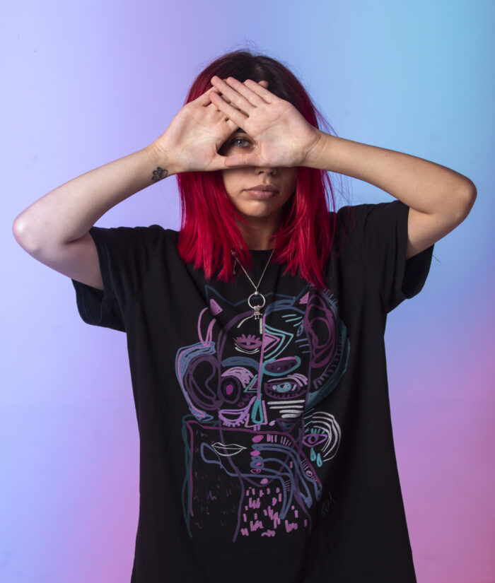 Young girl with pink hairs crossing her hands to her face